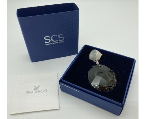 A boxed 2010 Swarovski Crystal Society "Earth" brown crystal window/hanging light catcher. Complete with box, and care instru