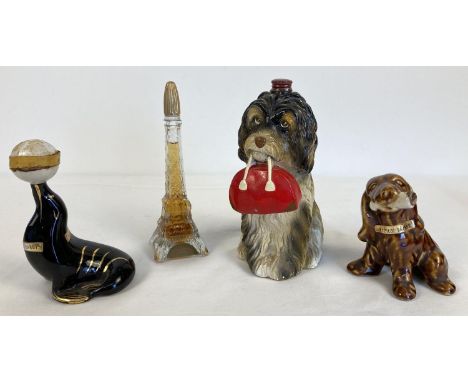 4 vintage novelty alcohol decanters. A Hasta Un Decilitro dog holding a bag, A glass Eiffel Tower cognac decanter, a ceramic 