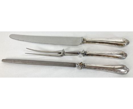A vintage white metal, shaped handled carving set to include knife sharpener. Shell style design to ends of handles. 