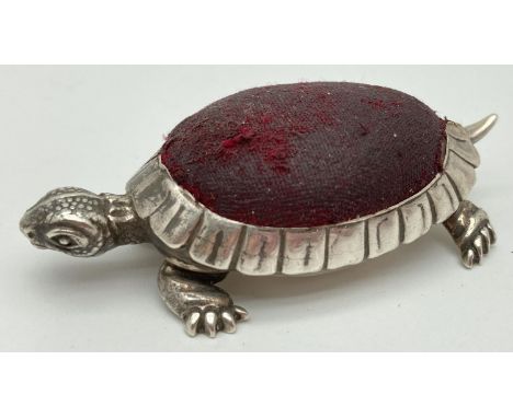 An Edwardian silver novelty pin cushion in the form of a tortoise with worn red fabric cushion. Hallmarked to underside Birmi