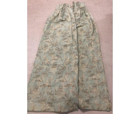 A pair of heavy lined curtains in a duck egg blue with a brown and beige floral pattern. Approx. 138 x 208cm. 