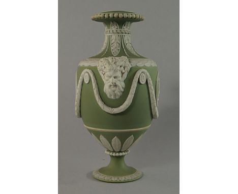 A Wedgwood sage green jasperware urn, 19th century, moulded with twin face handles, with classical medallions to the body, be