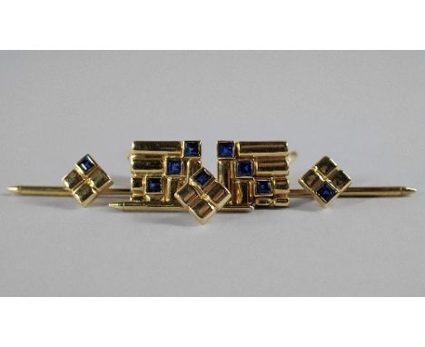 A pair of 18ct gold and sapphire set gentleman's cufflinks, of square ribbed form, set diagonally with three square cut sapph
