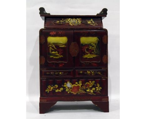 Japanese lacquered table cabinet, red lacquered with gilt decoration, landscape scenes, cupboards to reveal six assorted draw