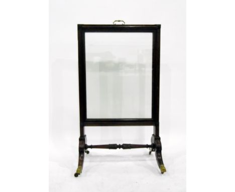 Georgian mahogany firescreen with glazed panel, on splayed legs with brass cap castors, united by central stretcher, height 1