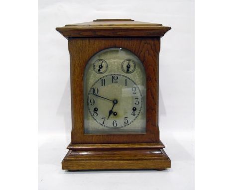 Edwardian oak mantel clock in architectural style case, having round-arch engraved dial with chime silent and slow/fast dials