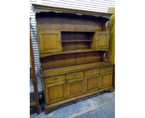 Reproduction stained fruitwood dresser, the three-tier platerack with pair of cupboards, the base with four drawers and four 
