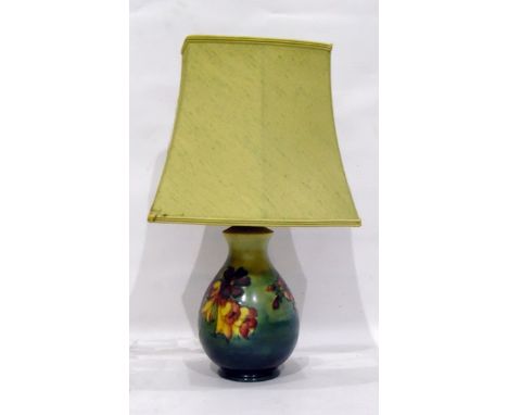 Moorcroft pottery table lamp, baluster-shaped with tube-lined decoration of various flowers, on a blue/green ground, 20cm hig