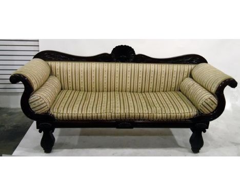 Regency mahogany sofa, the double scroll back rail with large central carved scallopshell, foliate carving, carved scroll end