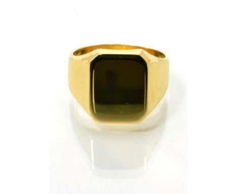 An 18 carat gold signet ring, with a oblong top to a tapering shank, finger size N1/2 12.1g