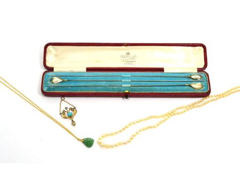 An Art Nouveau turquoise and pearl pendant, a round cabochon turquoise in a rubbed over setting within a heart-shaped frame, 
