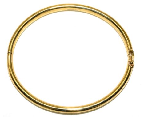 A 9 carat gold bangle, measures 6cm by 5.2cm inner diameter 26.9g