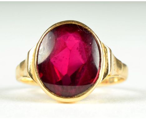 A synthetic ruby ring, a round mixed cut synthetic ruby in a rubbed over setting, to tapered shoulders, finger size M1/2, sta