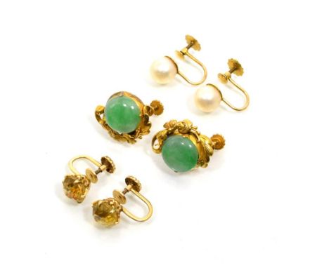 A pair of jade earrings, round cabochon jade to a foliate scroll half frame, measure 1.5cm in diameter, stamped '14K' and a p