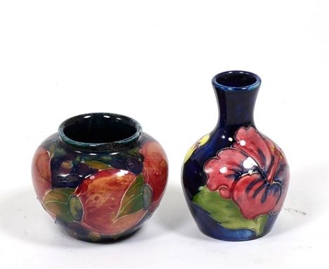 A Walter Moorcroft Hibiscus vase and a William Moorcroft Pomegranate vase (a.f.) (2) 