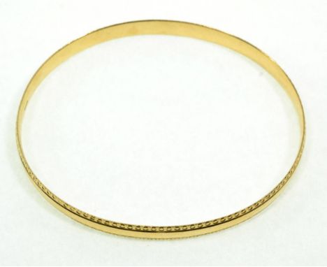 A 9 carat gold bangle, with a decorative border, measures 7cm by 6.5cm inner diameter, 6mm wide13.5g