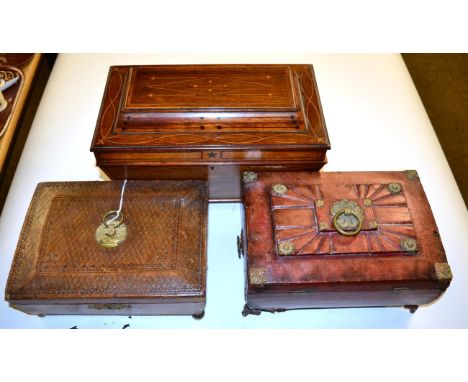 A 19th century inlaid tea caddy; and two tooled leather sewing caskets (3) 
