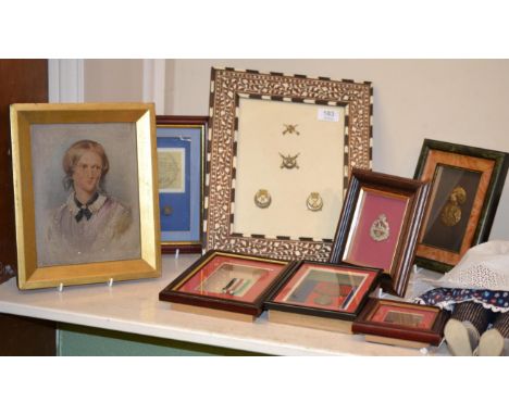 Militaria in seven glazed displays, containing:- Australian Peace Medallion 1919 with shoulder title and cap badge; Second Wo