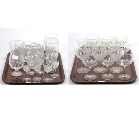 A set of six cut glass champagne saucers; six further engraved examples; and four start cut examples; a set of six Waterford 