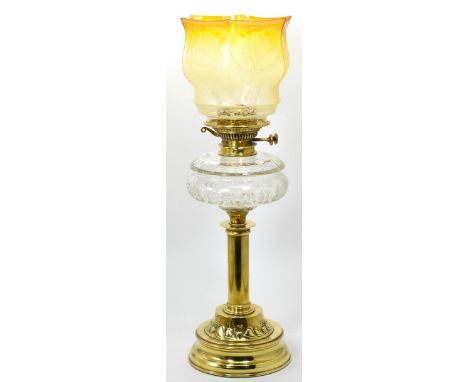 An oil lamp with yellow shade 