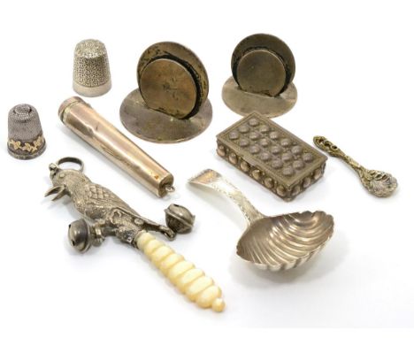 A group of small silver items comprising:a George III bright engraved caddy spoon; a child's rattle in the form of a bird; a 