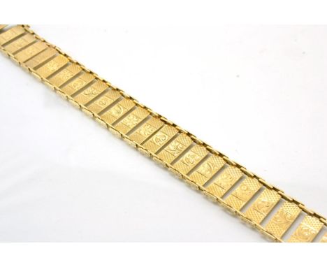 A bracelet, of engine turned and foliate chased rectangular links, length 18cm, stamped '9CT'Good condition. 15.8g