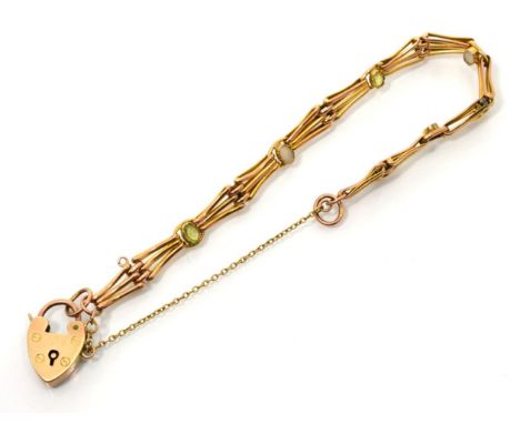 A peridot and mother-of-pearl bracelet, gate links set with alternating oval cut peridot and mother-of-pearl plaques, to a pa