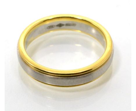 A platinum and 18 carat gold band ring, an inner brushed polished platinum band between two bright polished gold bands, finge