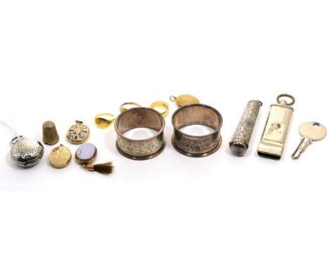 A silver sovereign holder; an amber cheroot holder in a silver case; two silver napkin rings; a silver key and a combined ''G