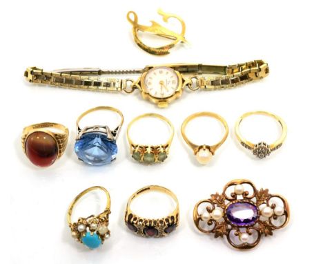 A 9 carat gold agate ring, an oval cabochon agate in a rubbed over setting, to fluted shoulders, finger size M; a 9 carat gol