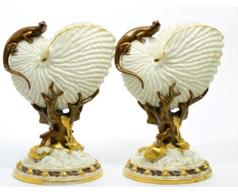 A pair of Royal Worcester nautilus shell vases, with applied lizards, blush ground and gilt enriched, marks to bases (2)