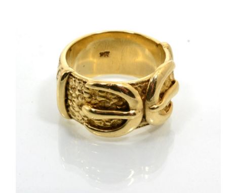 A large buckle ring, of a double buckle motif, with chased decoration, finger size Z+3, stamped '9CT'27.9g