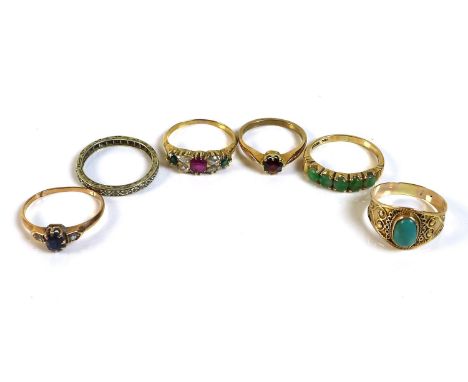 A group of six gold and unmarked metal rings, comprising a Victorian / Edwardian seven stone ring, set centrally with a ruby,