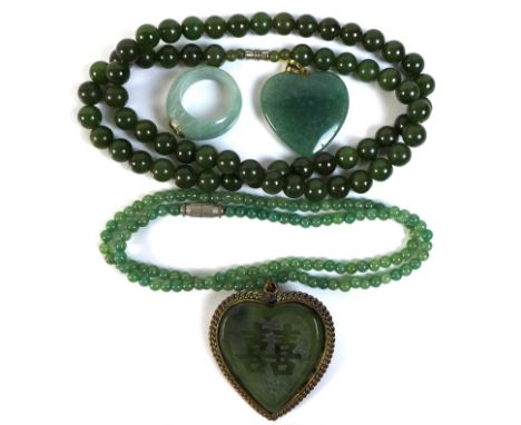 A jade ring set with a peridot in a 14ct gold mount, size N, 6.7g, together with an apple green stone bead necklace, possibly