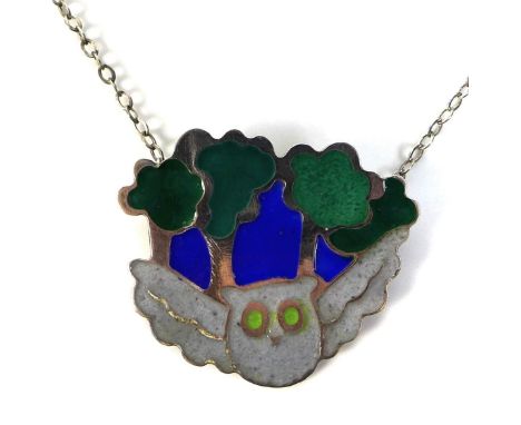 A silver and enamel necklace in the form of a grey owl flying in a midnight forest, enamelled in blues, greens and grey, on s