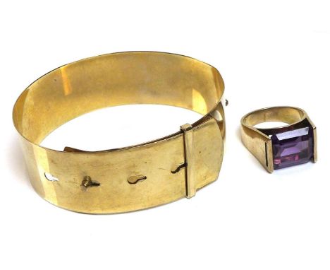 A 9ct gold buckle bangle bracelet, 14.8g, together with a modernist design 9ct gold and emerald cut amethyst ring, amethyst a