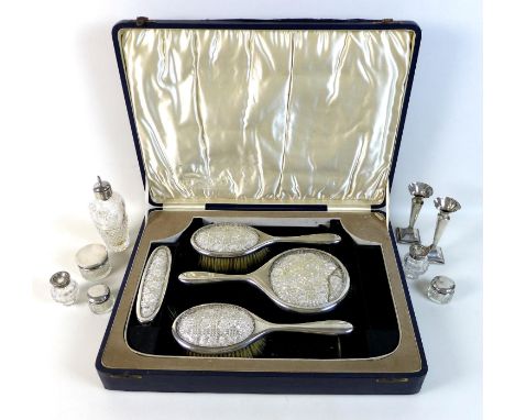 A group of George V silver dressing table items, comprising a cased part set silver and glass backed dressing table set, with