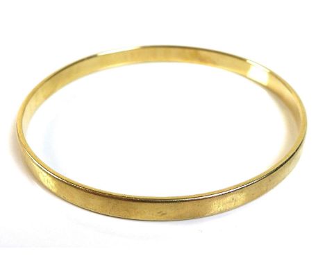 A 14K yellow gold bangle, of plain form, marked '585', 6.3cm internal and 6.7cm external diameter, 21.9g. 