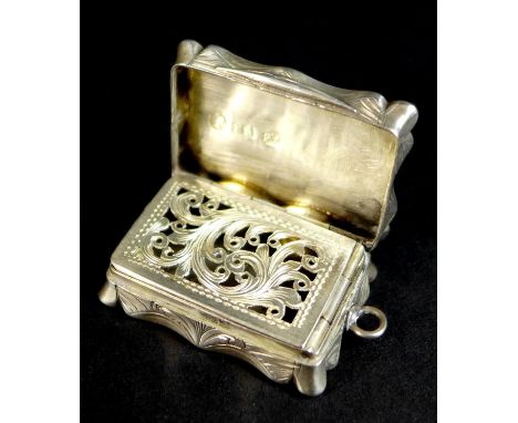 A Victorian silver vinaigrette, of shaped rectangular form, with wave engine turned decoration to the lid, and base, central 