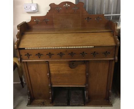 A vintage pedal organ by R.F. Stevens with decorative top & front panel. Approx 101 x 112cm.