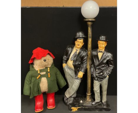 A Novelty Laurel and Hardy table lamp, white globular shade, approx 85cm high overall;  a Gabriel Designs Paddington bear, re