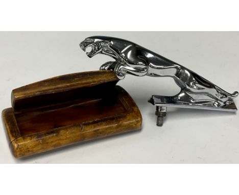 A rectangular walnut snuff box, mother of pearl inlay; a Jaguar chrome car mascot (2)