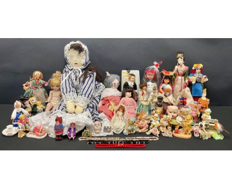 A cold painted lead doll, as a Welsh Lady, signed, 25cm; a bisque doll's head; other dolls; a canon; a large cloth/rag doll; 