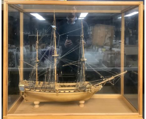 A large handmade model ship, gilded features, glass display case measuring 79.5cm x 92cm x 35cm