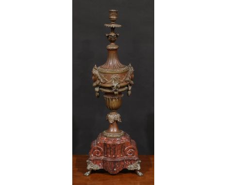 A French fin de siècle bronze and rouge marble table lamp, cast with masks, scrolls and acanthus, fruiting laurel socle, arch