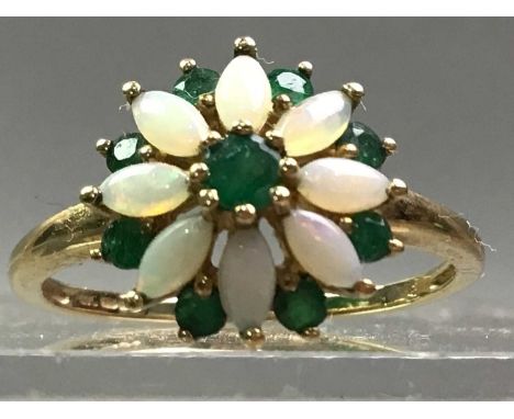 NINE CARAT GOLD, OPAL AND EMERALD DRESS RING of floral designThe ring is a size Q.