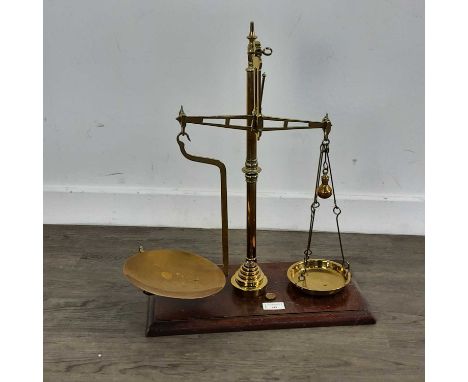 SET OF BRASS PAN SCALES BY ANDERSON OF GLASGOW on a mahogany base with seven cup weights