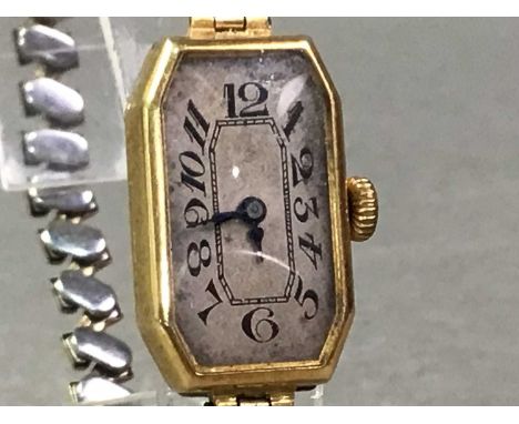 EIGHTEEN CARAT GOLD CASED MANUAL WIND WRIST WATCH with engraved caseback, on a gold plated expanding bracelet
