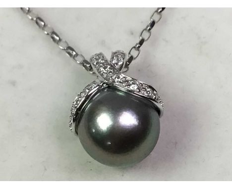 NINE CARAT WHITE GOLD, DIAMOND AND DYED PEARL PENDANT suspended on a nine carat white gold belcher chain