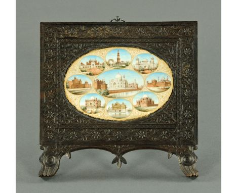 An Indian carved wooden easel backed picture frame, with images of the Taj Mahal, etc., on ivory, frame width 20 cm (see illu